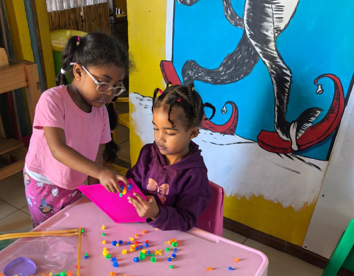 Children working together with scissors and paper
